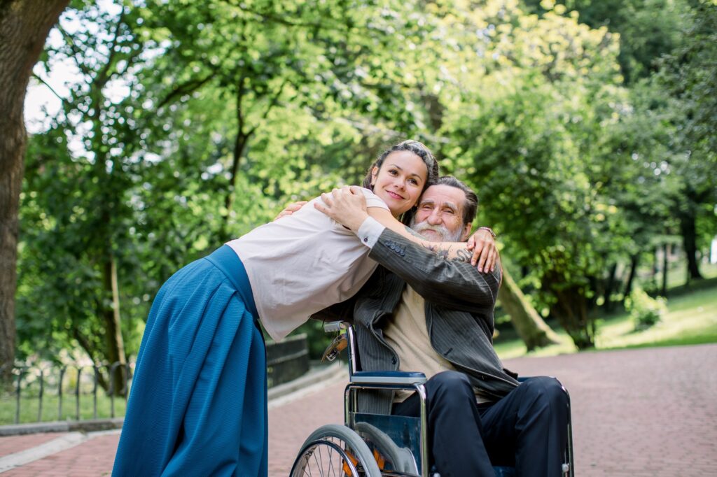 Disabled people, palliative care. Lifestyle summer portrait of senior bearded man in wheelchair